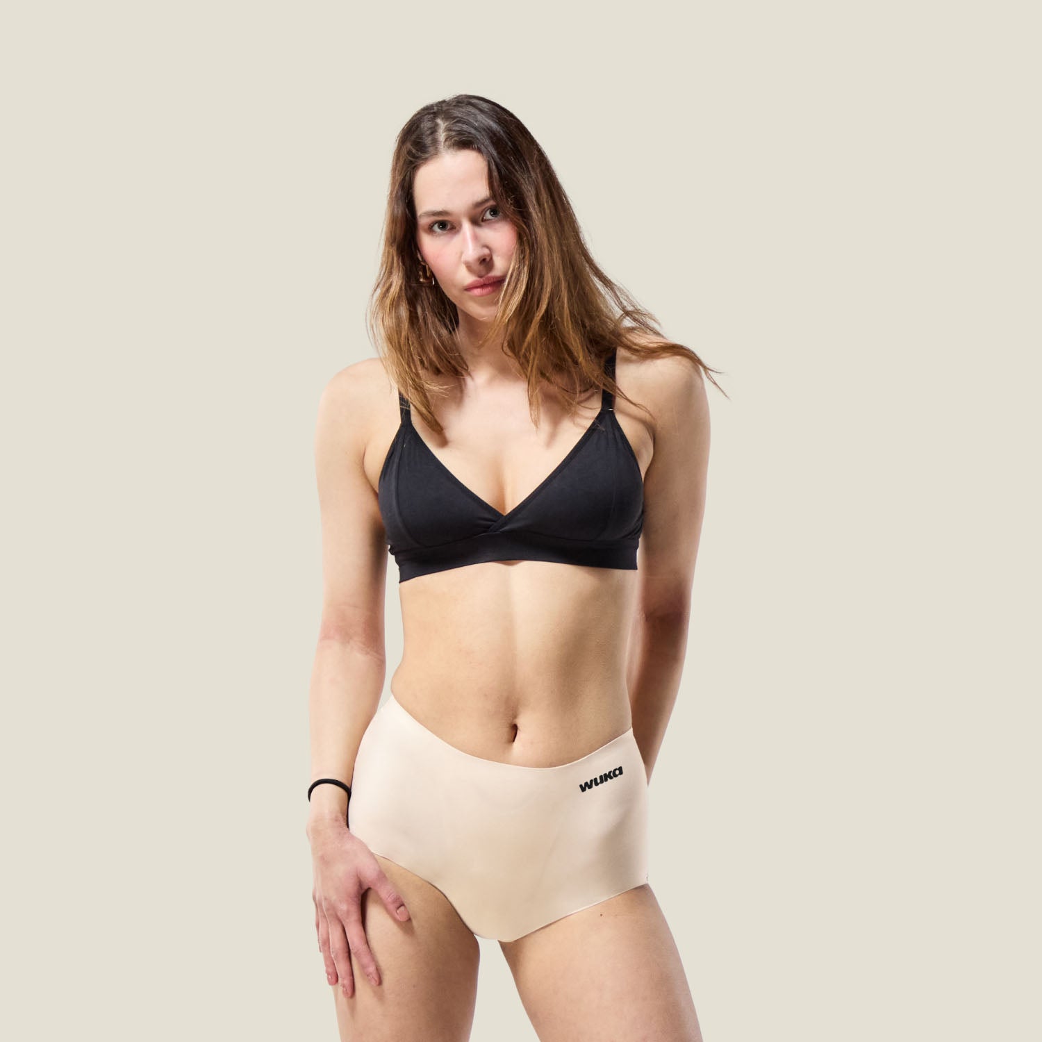 Model wearing WUKA Stretch™ Boxer Short in Light Nude for heavy flow, full-body view showing seamless fit and high-waisted comfort.