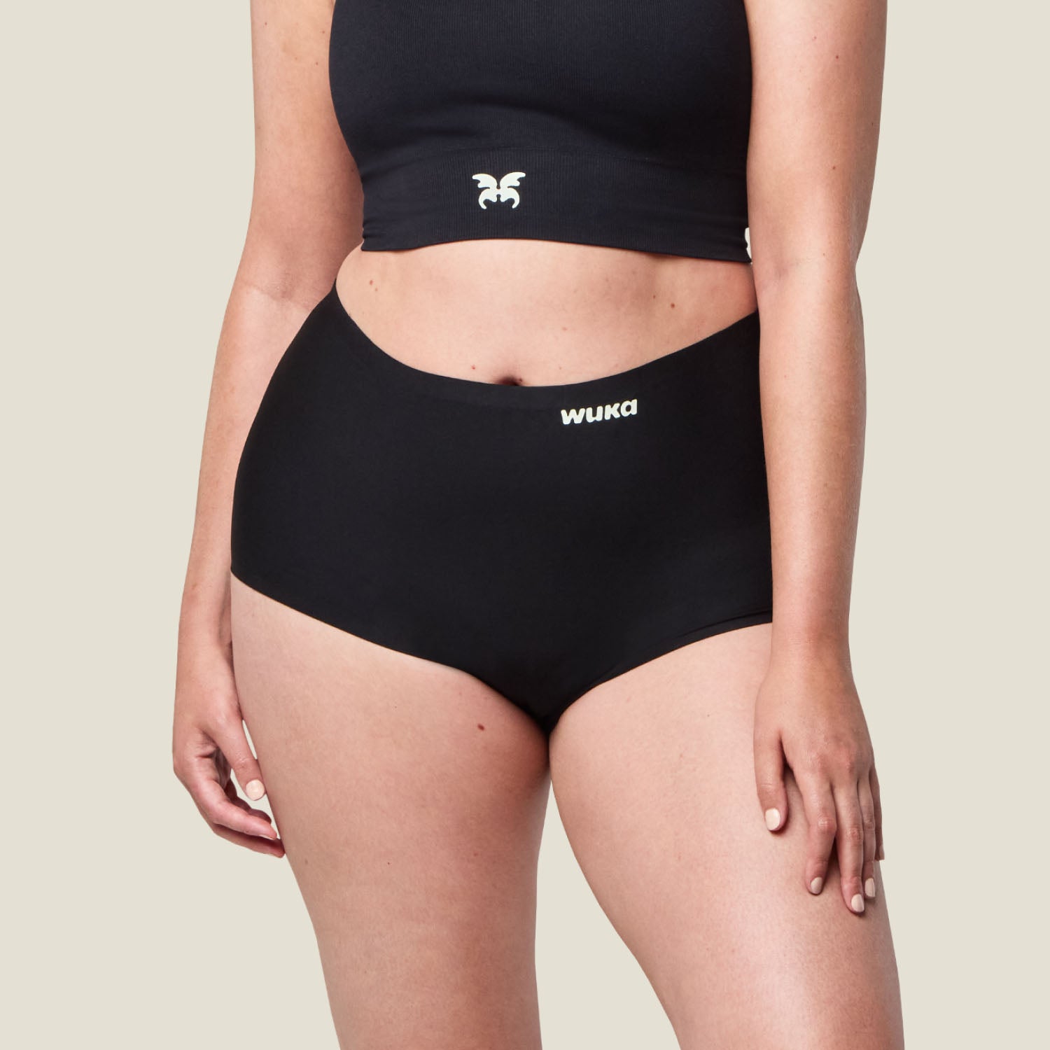 Close-up of WUKA Stretch™ Boxer Short in black showing the front panel and WUKA logo, period underwear for heavy flow protection.