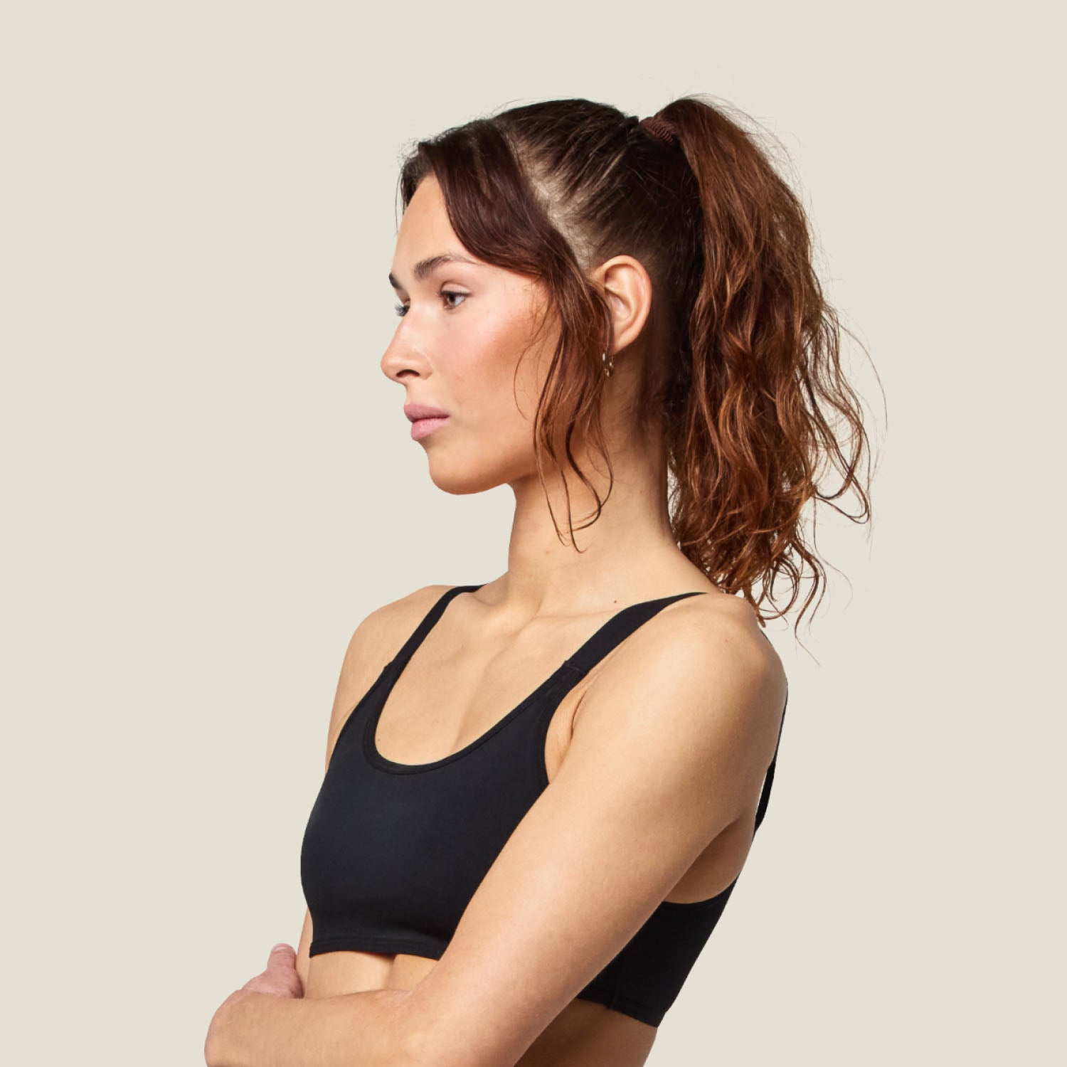 Side profile of the Teen Swim Bikini Top in Black, highlighting the snug, supportive fit and athletic styling.