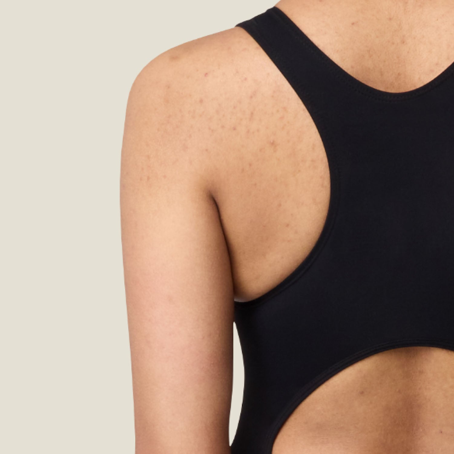 Detailed close-up of racerback period swimsuit material – showing soft, stretchable fabric designed for discreet protection and movement