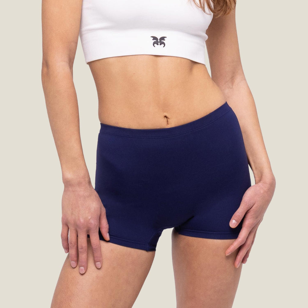 Adult female wearing navy blue swimming short by WUKA