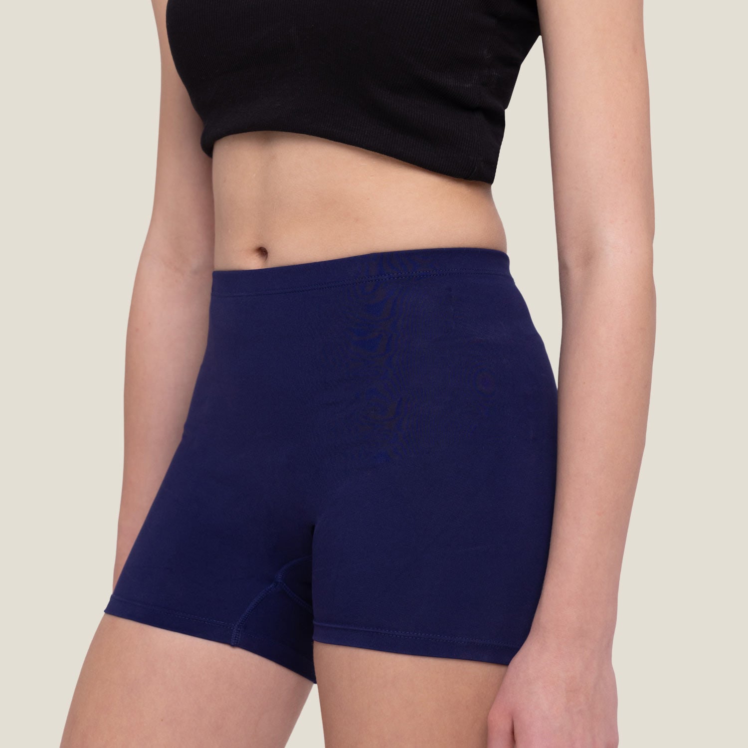 Female wearing navy blue WUKA teen shorts and a black top