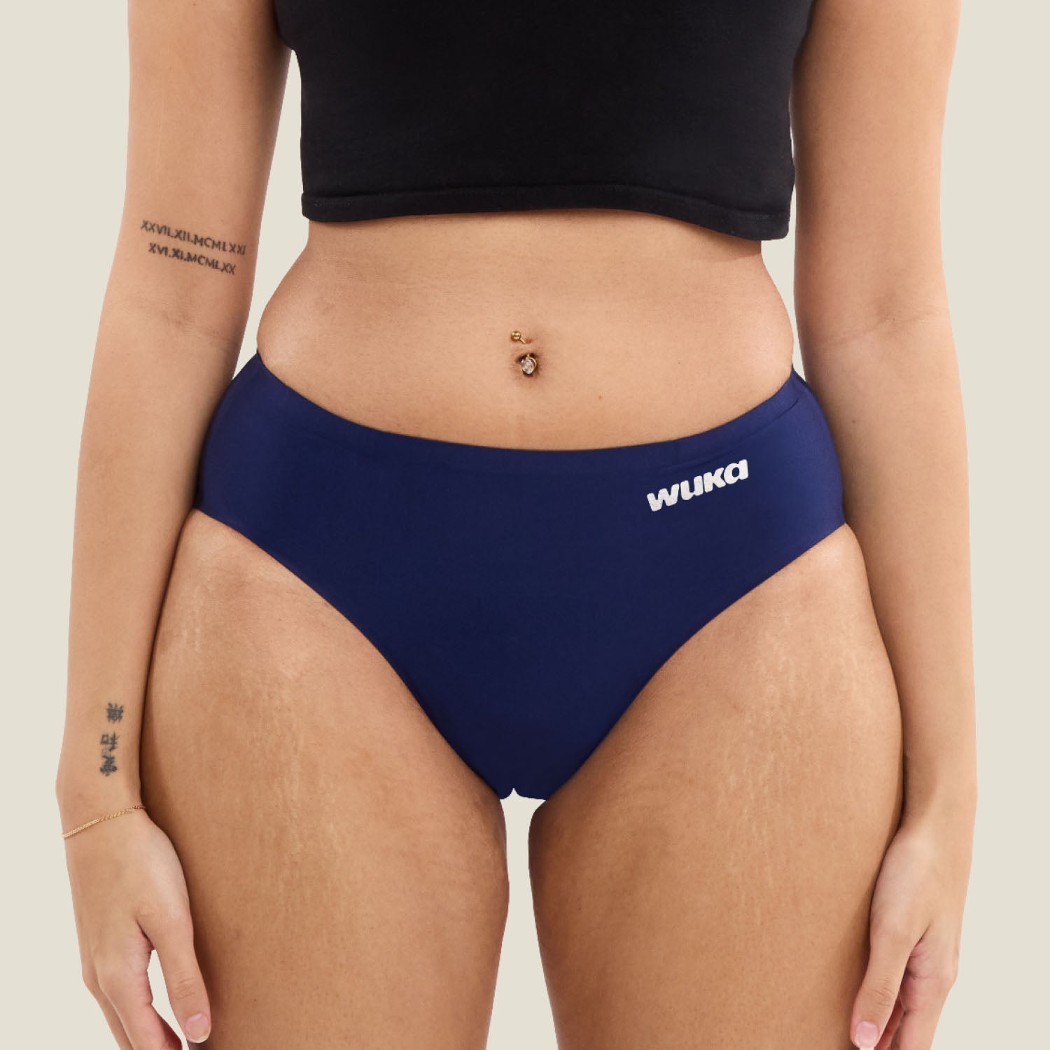 Front view of a teen wearing WUKA Teen Stretch™ Seamless Midi Brief in navy, leak-proof teen period pants.
